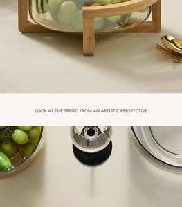 Detail of amber glass salad bowl with bamboo wood stand for tabletop fruit storage