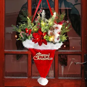 Lighted Christmas hat basket with berries, greenery and Santa on a rustic door