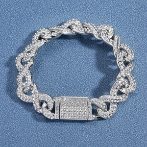 Detail of silver iced-out Cuban chain necklace with micro-paved rhinestones and box clasp