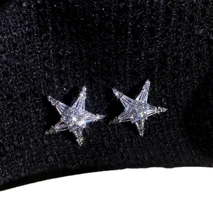 Elegant silver starfish stud earrings with cubic zirconia stones on black background
