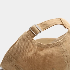 Detail of adjustable metal silver buckle on khaki cotton twill baseball cap back