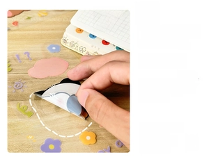 Close-up of waterproof cartoon stickers showing panda and flowers on wood surface