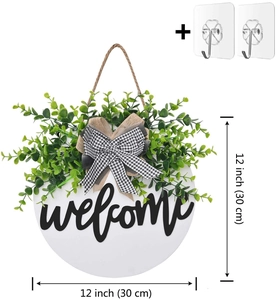 Detail of 12-inch Welcome wooden door wreath with green foliage and hanging hooks
