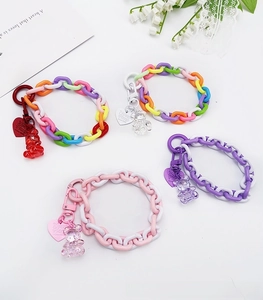 Close-up of colorful acrylic chain wrist straps with cute resin bears and heart charms