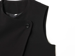 Detail of the V-neckline and button closure on a black sleeveless woven vest, size S