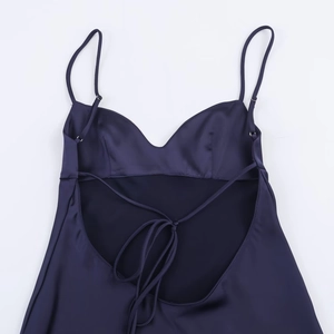 Detail der Schnürung am Rücken des dunkelvioletten Satin-Kleides mit dünnen Trägern