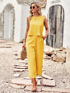 Detail view of yellow two-piece set featuring a sleeveless top and wide-leg trousers