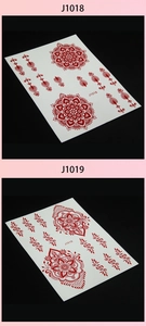 Macro detail of red henna tattoo stickers with J1018 and J1019 mandala lace patterns
