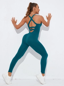 Detail of cross-back straps on a seamless backless yoga bodysuit in dark teal