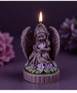 Detailed view of angel figurine candle with purple floral base and lit flame