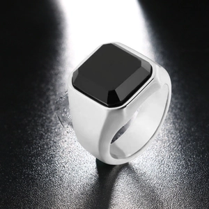 Macro shot of square black faux obsidian stone on a wide silver band for men
