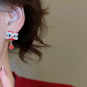 Close-up of pearl earrings with red lion dance motif and golden coin pendant decoration