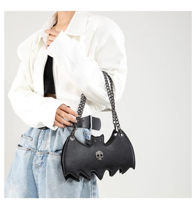 Close-up of black bat-shaped jelly bag with silver skull charm and metal chain strap