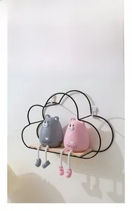 Close-up of wall-mounted cloud iron shelf with wood board and sweet bear figures