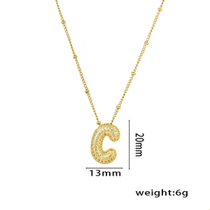 Detail showing 13mm by 20mm 18K gold plated letter C pendant with zircon stones