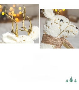 Detailed view of white reindeer ornament with golden antlers and sparkly sequin scarf