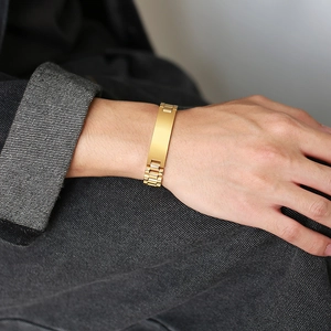 Detail of gold titanium steel link bracelet with rectangular bar worn on wrist