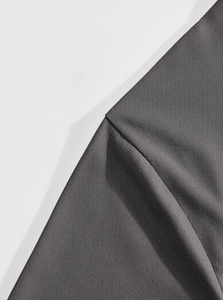 Close-up of dark grey stretch fabric showing premium texture and breathable weave details