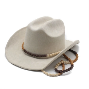 Detail of cream western cowboy hat featuring intricate beaded band and matte felt texture