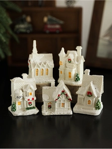Detail of five mini resin Christmas snow houses with Gift and Toyshop signs for decor