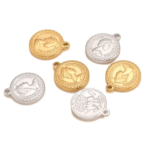 Close-up of gold and silver Elizabeth II coin pendants with embossed 1891 vintage details