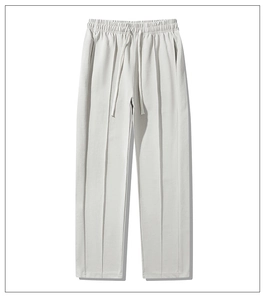 Detailed macro shot of light grey casual trousers with elastic drawstring and vertical seams