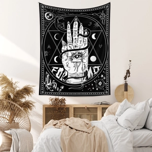 Detail of Hamsa Hand and moon phases tapestry hanging in a cozy bohemian bedroom decor