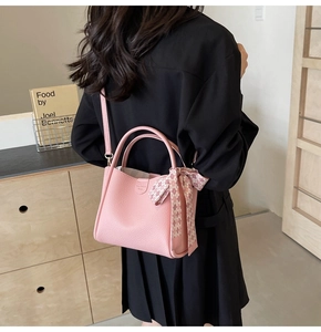 Pink lychee grain bucket bag with floral silk scarf detail and slim shoulder strap