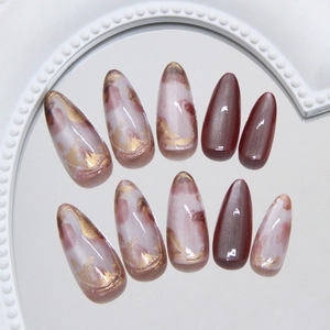 Long almond cat eye press on nails with amber marble texture and gold foil accents