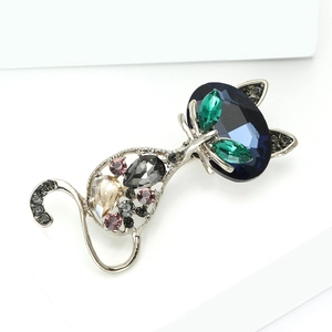 Detailed macro view of a vintage cat brooch with colorful inlaid rhinestones and crystals