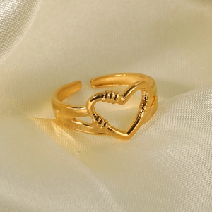 Elegant gold heart open ring with adjustable band on luxury silk fabric background