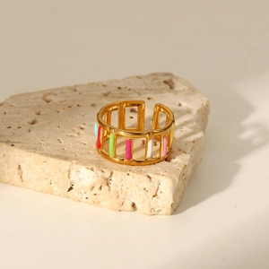 Macro view of 18K gold plated hollow ring with colorful enamel inlay on stone
