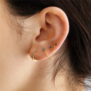 Detail of S925 silver gold-plated ear set with blue zircon studs and chain earring