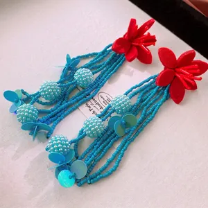 Bohemian floral tassel earrings with red felt flowers and turquoise bead strands