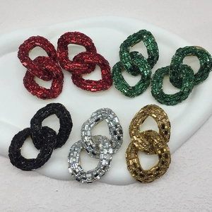 Macro shot of chain-link earrings featuring multi-colored crystals in a five-color display