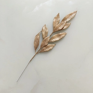 Detailed view of champagne gold glittery artificial branch for Christmas holiday decoration