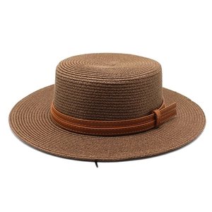 Detailed view of dark brown woven straw flat top hat with premium brown leather strap