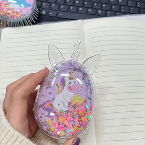 Detail of transparent unicorn hair brush with purple glitter and moving sequins