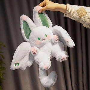 Cute white bat bunny plush toy with green wings and large ears held in hand