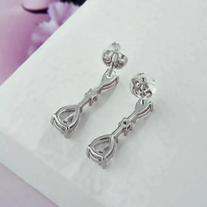 Elegant silver teardrop earrings with pear-cut crystals and silicone backs shown from side