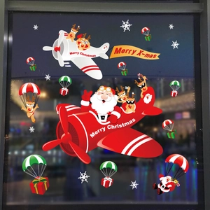 Christmas window decals with Santa flying a plane and reindeer parachute decorations