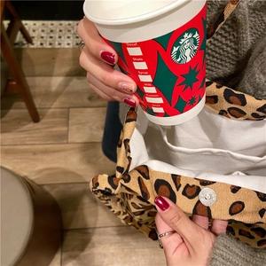 Detail view of leopard print corduroy tote bag featuring magnetic snap closure and inner pocket