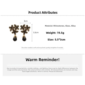 Detail view of vintage bronze flower earrings with black crystals and 5.5x3cm dimensions