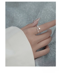 Detail of S925 sterling silver star ring with zircon accents on hand model