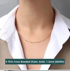 Detailed view of a 1.2mm gold-plated stainless steel beaded cross chain necklace for women