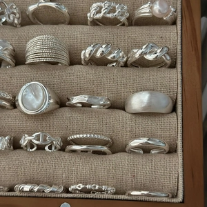 Vintage S925 sterling silver rings set with pearls and gemstones in a jewelry box