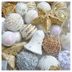 Detail of glittery champagne gold and white Christmas ornaments with sequins and pearls