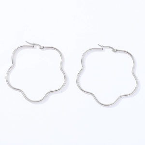 Macro detail of silver stainless steel hoop earrings with wavy petal-shaped edges