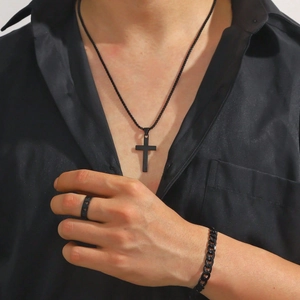 Men's black jewelry set with cross pendant necklace, ring and chain bracelet on model