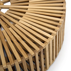Detailed macro view of the radial bamboo strips and wooden bead weaving on the handbag